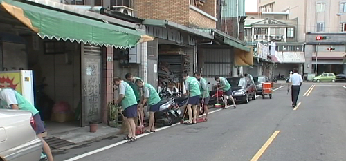 Inmates assist to clean the road